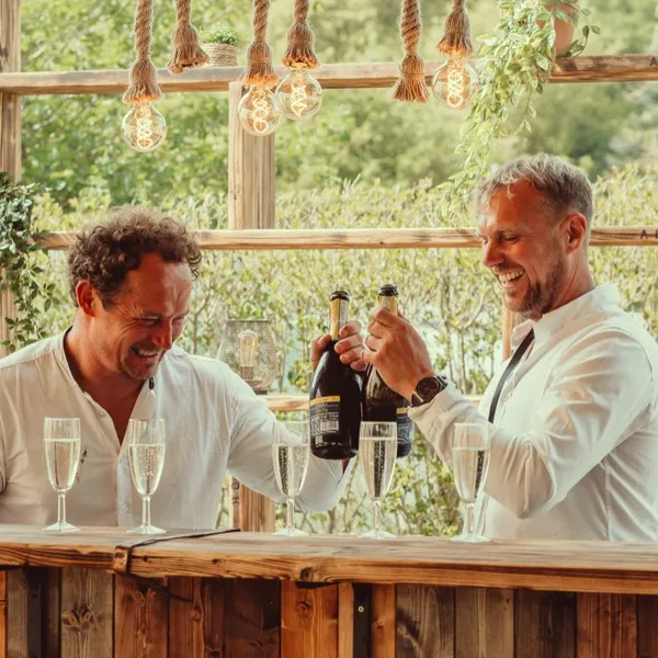 Guests toasting with champagne at the outdoor bar