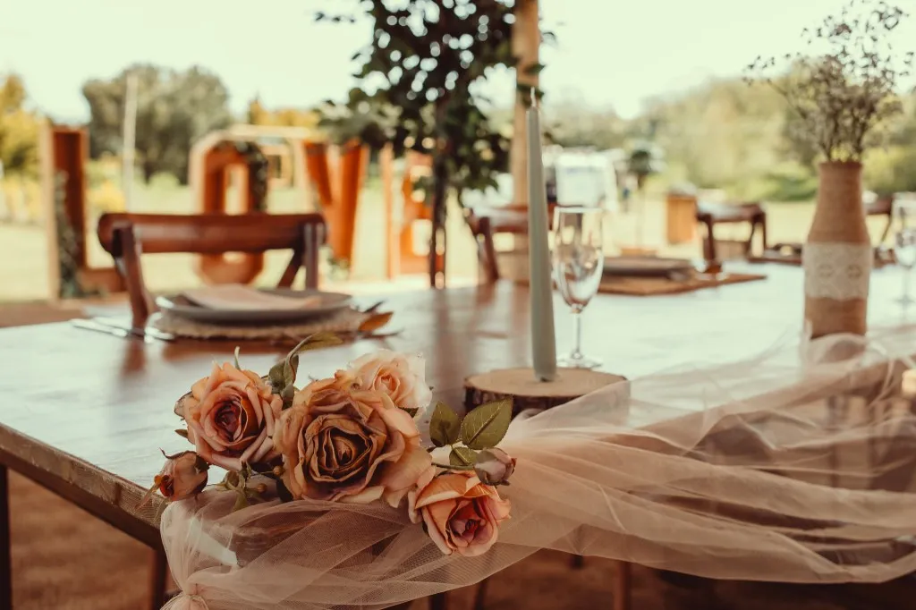 Roses and table settings at a wedding reception at Woodhill Weddings, Faversham, Kent