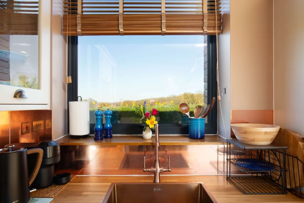 Kitchen sink and window overlooking the Kent countryside at an Enchanted Lodge, Woodhill Weddings, Faversham, Kent