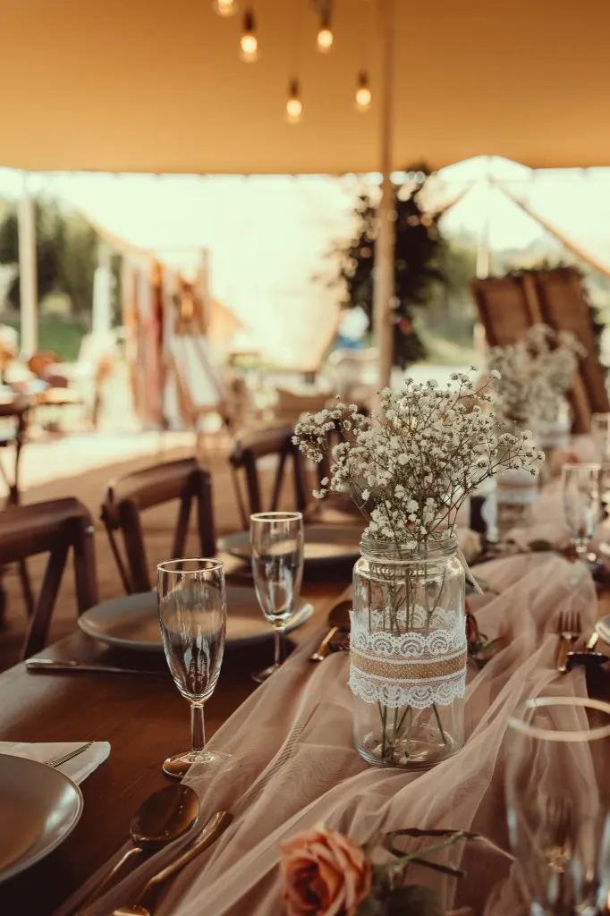 Wedding breakfast place settings under the stretch tent at Woodhill Weddings, Faversham, Kent